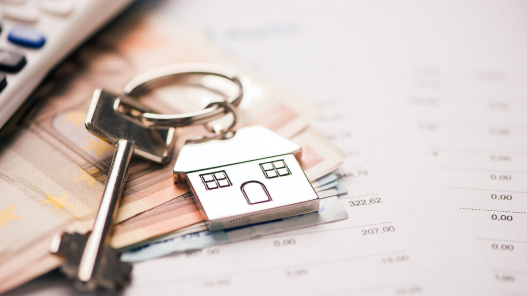 house keys on top of a signed mortgage agreement.